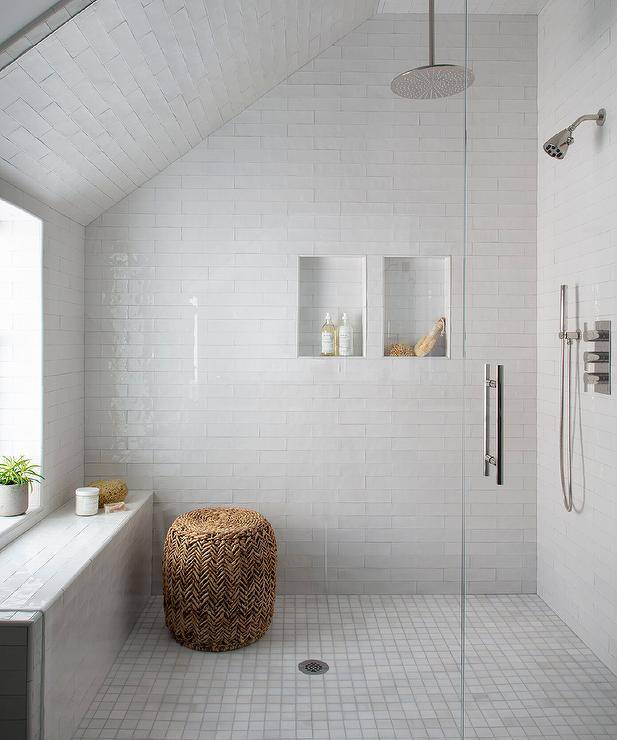 sloped ceiling walk in shower white clean tile with seagrass ottoman
