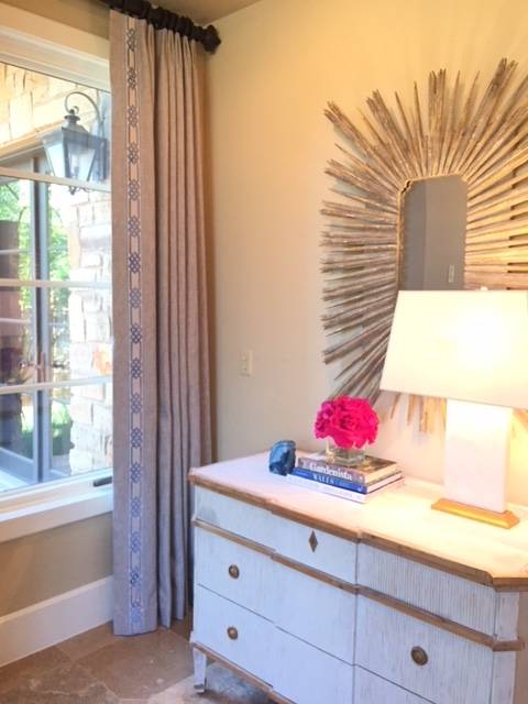 Beautiful entryway with custom drapery and a starburst mirror. Pink roses and a lamp from Circa Lighting brighten up the space and welcome guests near and far!