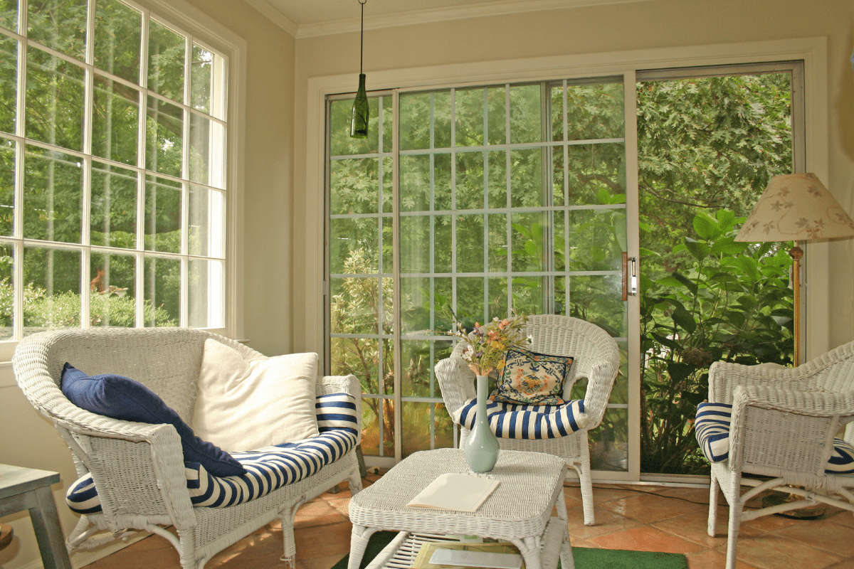 sunroom with white wicker chairs