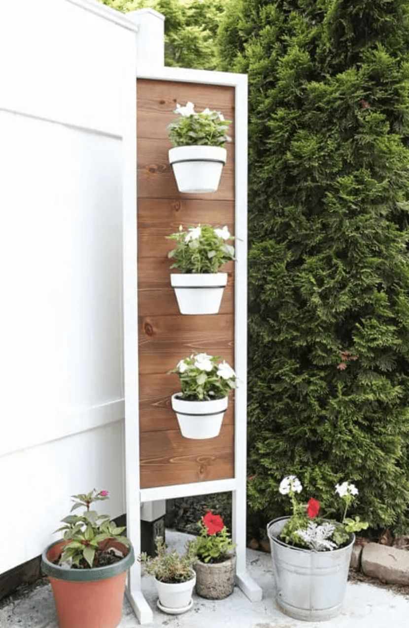 vertical white frame wood plant stand with white hanging pots
