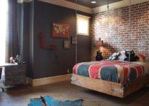 industrial vintage style boys bedroom with brick accent wall and chain hanging bed