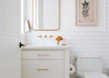 white neutral half bathroom with gold mirror and white vanity
