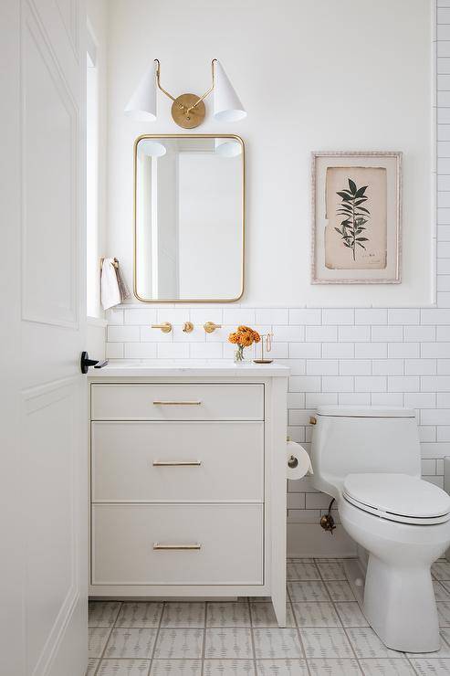 white neutral half bathroom with gold mirror and white vanity