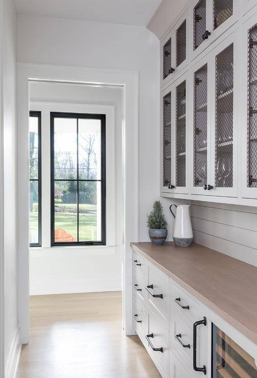 white cabinets with black wire mesh