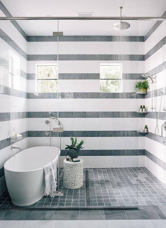 striped tile pattern wall walk in shower all glass doors with oval tub