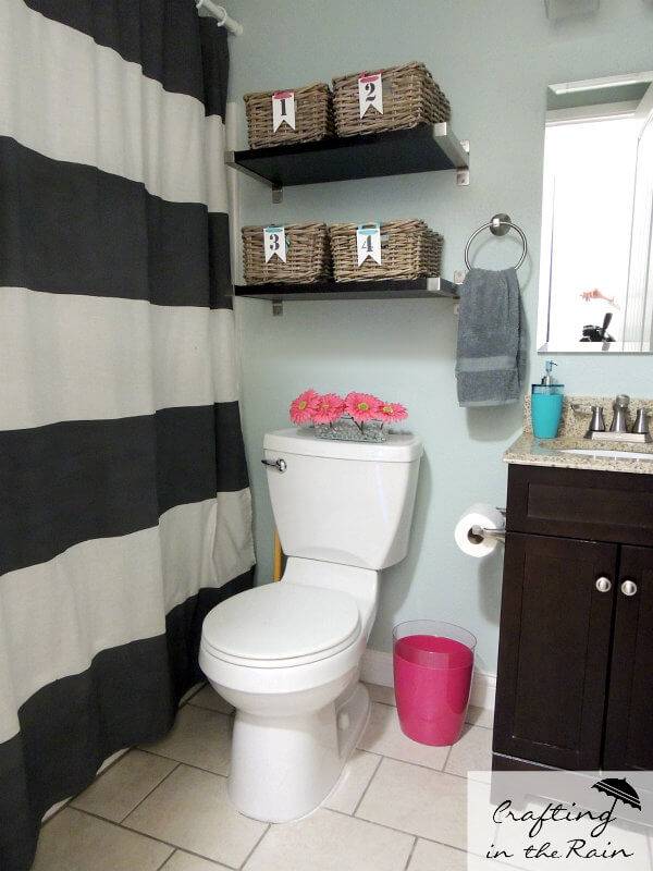 black and white striped shower curtain wood shelves with baskets over toilet storage