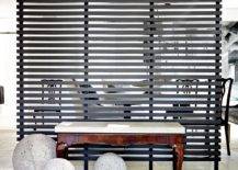 black wooden slats wall wood bench in front with cement decorative orbs