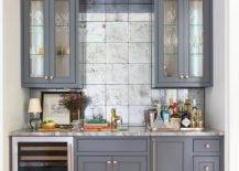blue greyish cabinets wet bar with wine fridge and mirrored square tile backsplash