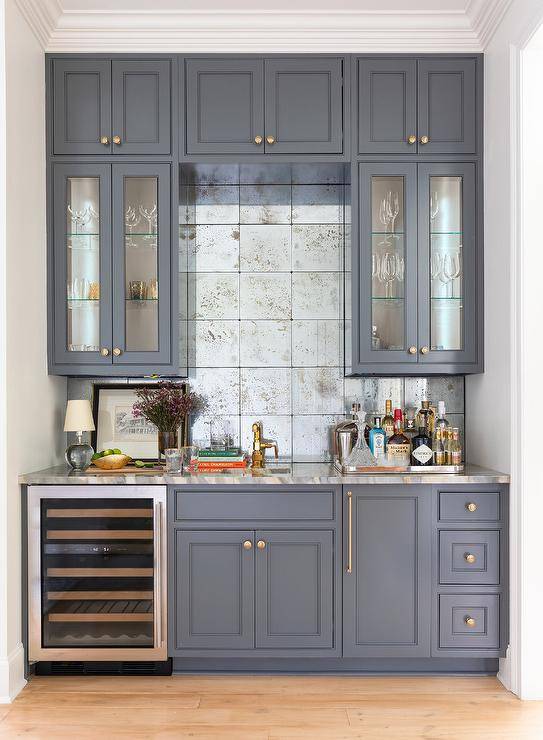 blue greyish cabinets wet bar with wine fridge and mirrored square tile backsplash