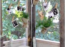 close up of chicken wire DIY room divider with hanging photos and greenery rustic chair in front outside