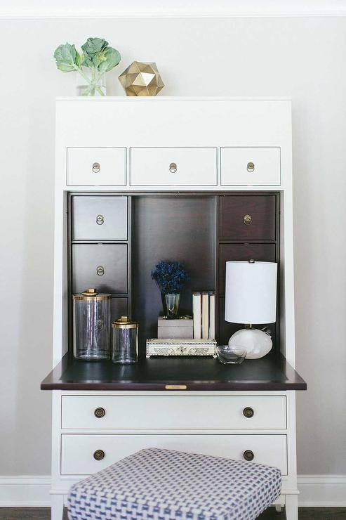 work space features a pull down secretary desk topped with glass and brass pharmacy canisters.
