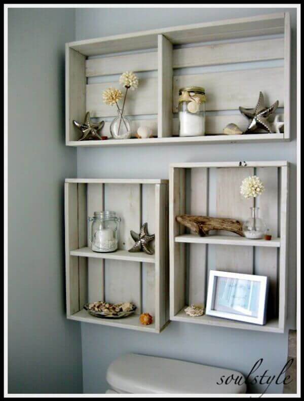 crates painted white and turned into decorative shelves and hung over a toilet