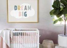 Nursery features Dream Big art on a pink ombre accent wall over a white Oeuf Sparrow crib and woven baskets on a light gray rug.