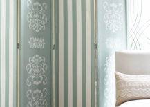 folding screen painted in robin's egg blue with strip pattern and damask behind a white french covered chair
