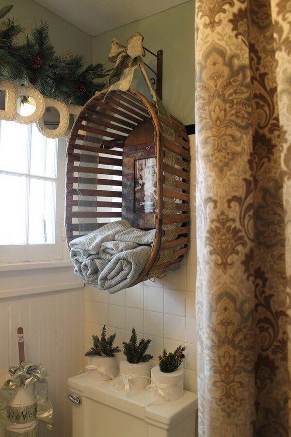 hanging oval basket as over the toilet storage in green bathroom