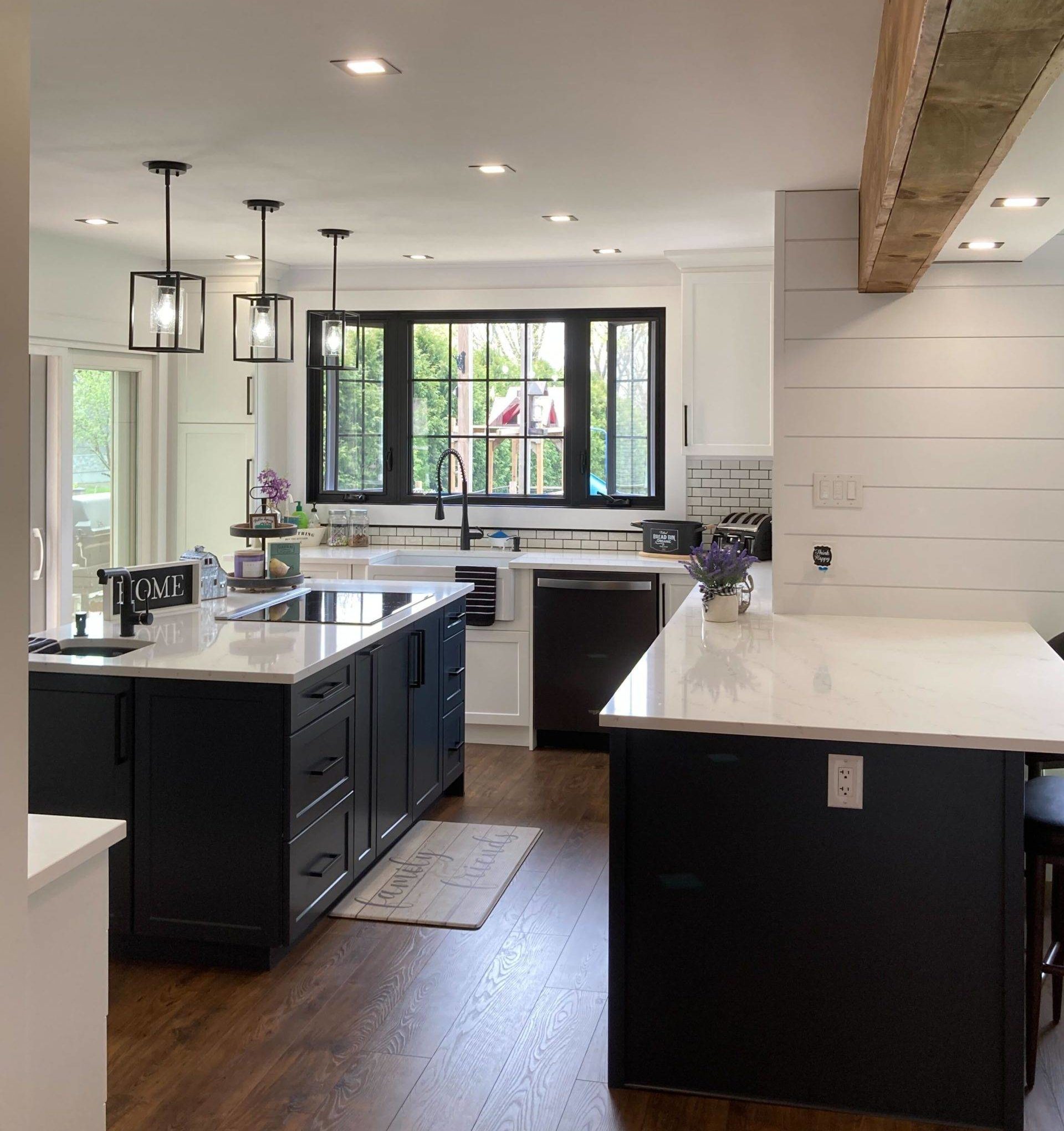 brightly lit kitchen with white countertops and window over sink