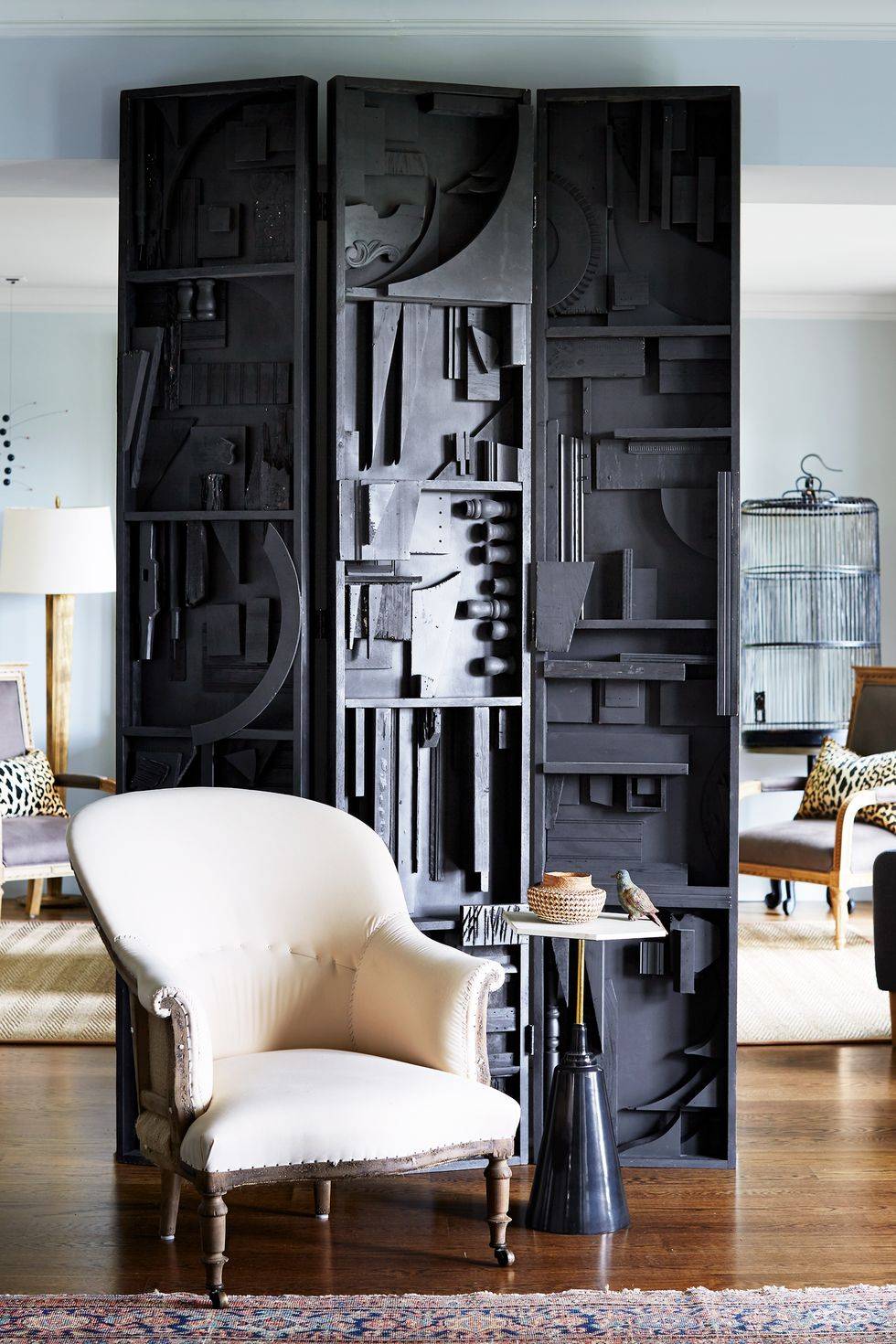 modern black room divider with white french club chair small table