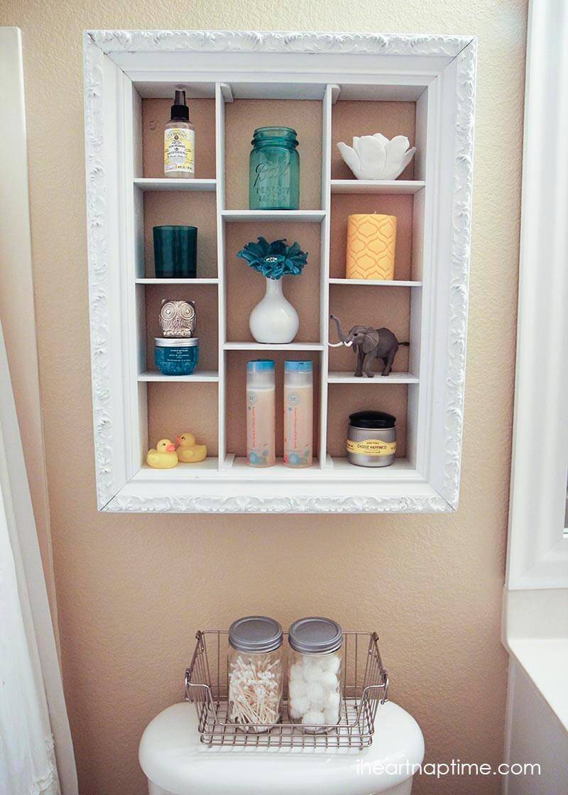 white picture frame turned shelf in bathroom over the toilet storage