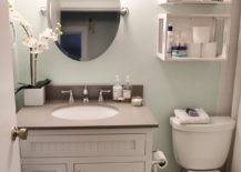white vanity in bathroom repurposed crates storage over the toilet oval mirror with wall sconces