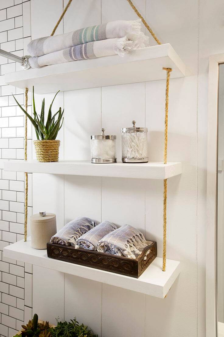 white shelf with hanging rope over the toilet storage ideas