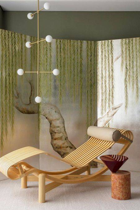 willow tree design on a room divider with rattan modern lounge chair white bulb gold chandelier