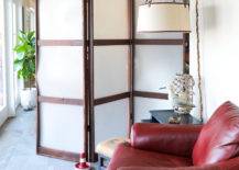 wood panel screen divider blocking off room red leather chair ceiling fan