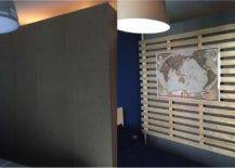 wood slat partition with world map in dark bedroom