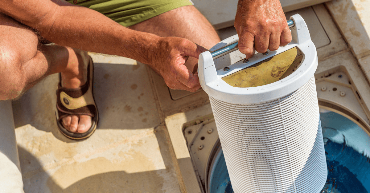 Person pulling out a pool filter cartridge. 