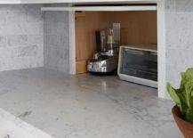 Small appliance garage cabinet stores and conceals items creating a minimalistic and clean aesthetic.