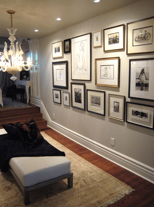 Beautiful foyer design with eclectic photo wall gallery, chandelier, fainting sofa, throw and soft gray walls paint color.