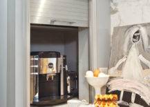 Kitchen features concealed coffee station hidden behind stainless steel garage door.
