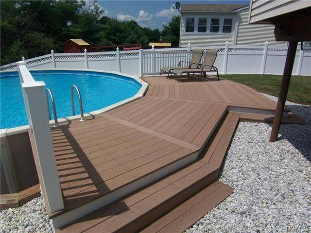 designer wood deck surrounding above ground circle pool