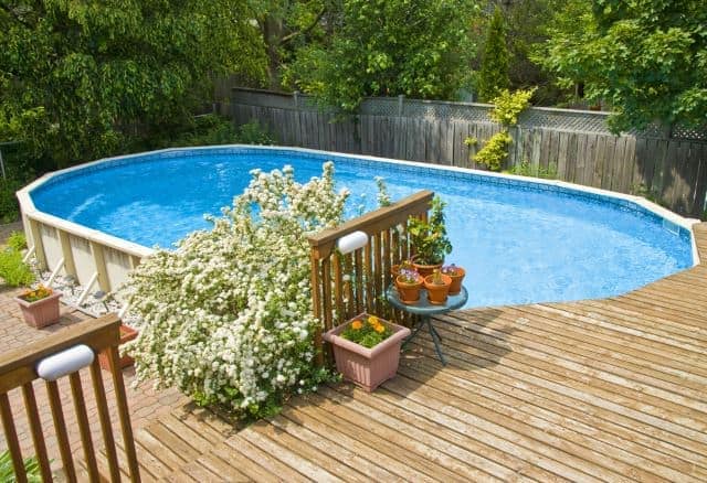 large oval above ground pool with deck