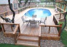 above ground pool framed in by large wood deck with seating and eating area patio furniture