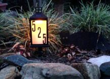 lantern house number sign in gardens on rocks lit up a night