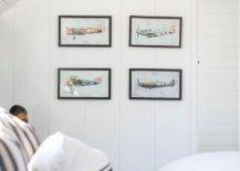 Boy's bedroom features vintage airplane prints on a vertical shiplap wall and a bed with blue and white bedding.