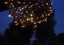 light up orb in backyard at night with string lights