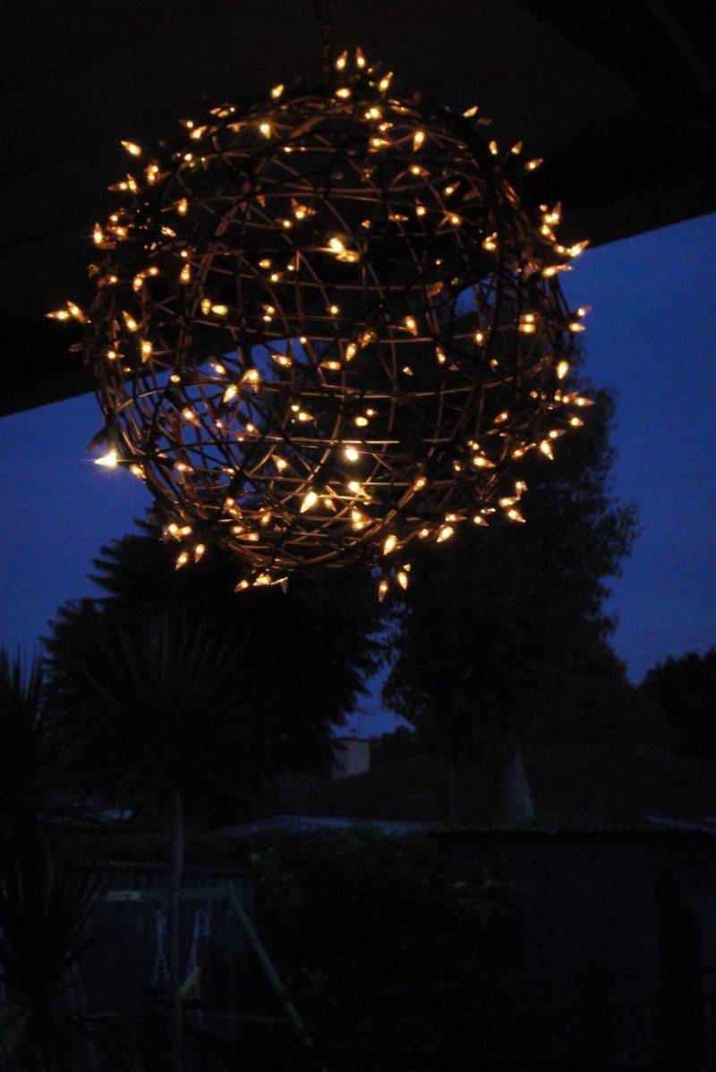 light up orb in backyard at night with string lights