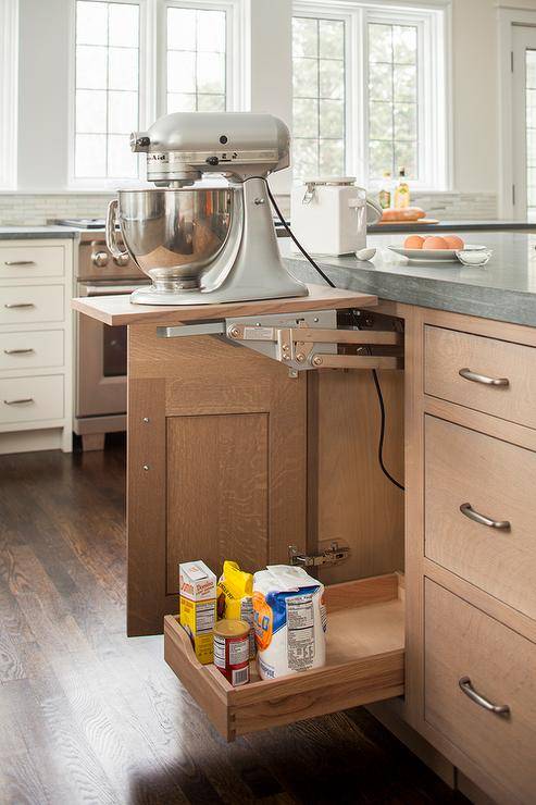 Fabulous kitchen features wire brushed oak cabinets fitted with a baking cabinet fitted with a lift up kitchen mixer shelf topped with Pietra Cardosa Limestone countertops.