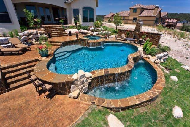 multi level above ground pool with brick stone edging