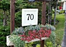 number house sign with planter wood beams on stone garden