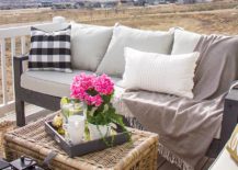 outdoor couch on porch with rattan chest coffee table throw pillows and throw blanket