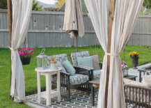 white drop cloth curtains on patio outside with rug and patio furniture