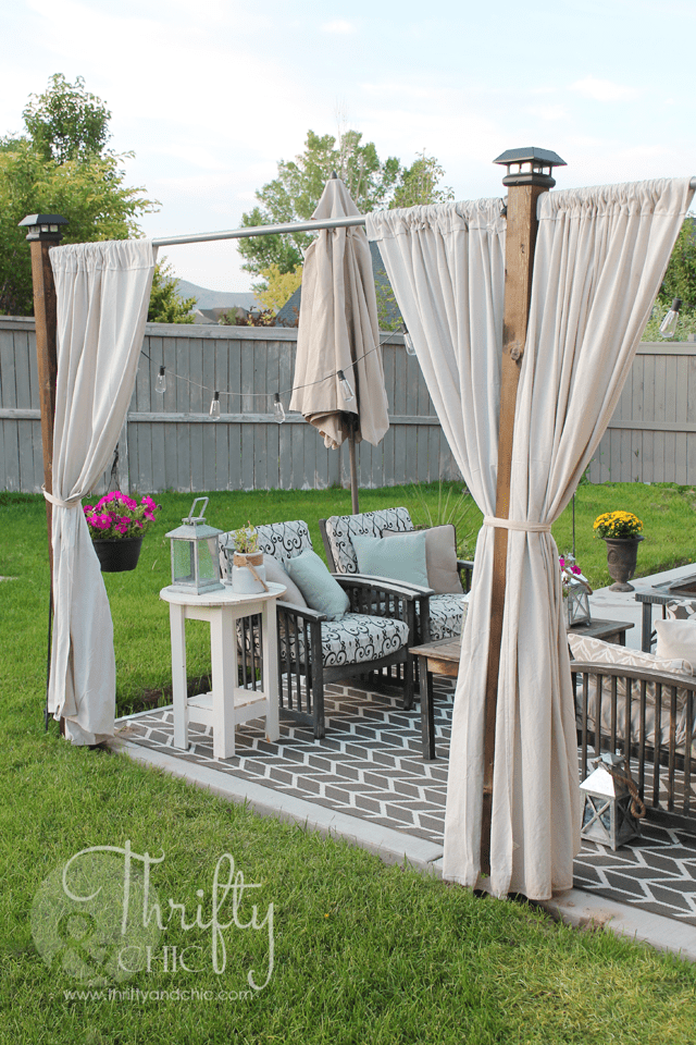 white drop cloth curtains on patio outside with rug and patio furniture