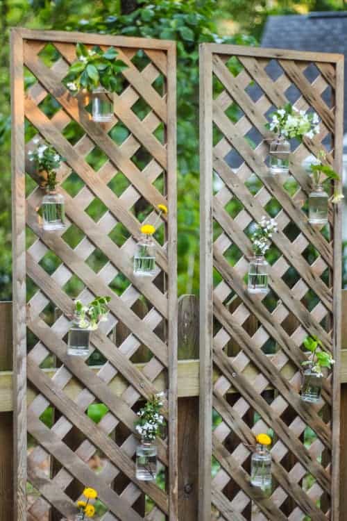 close up of privacy lattice with hanging mason jars