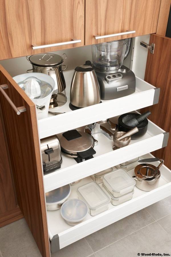 pull out cabinetry with wood appliance storage kitchen