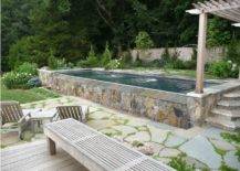 rectangle above ground pool with stone wall edging around it