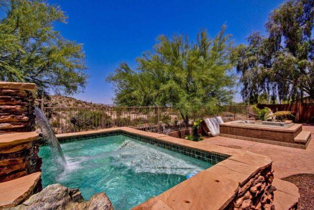 above ground pool framed in with terracotta rustic stone