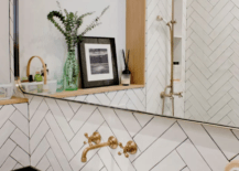White Herringbone tile with gold faucets bowl sink showerhead