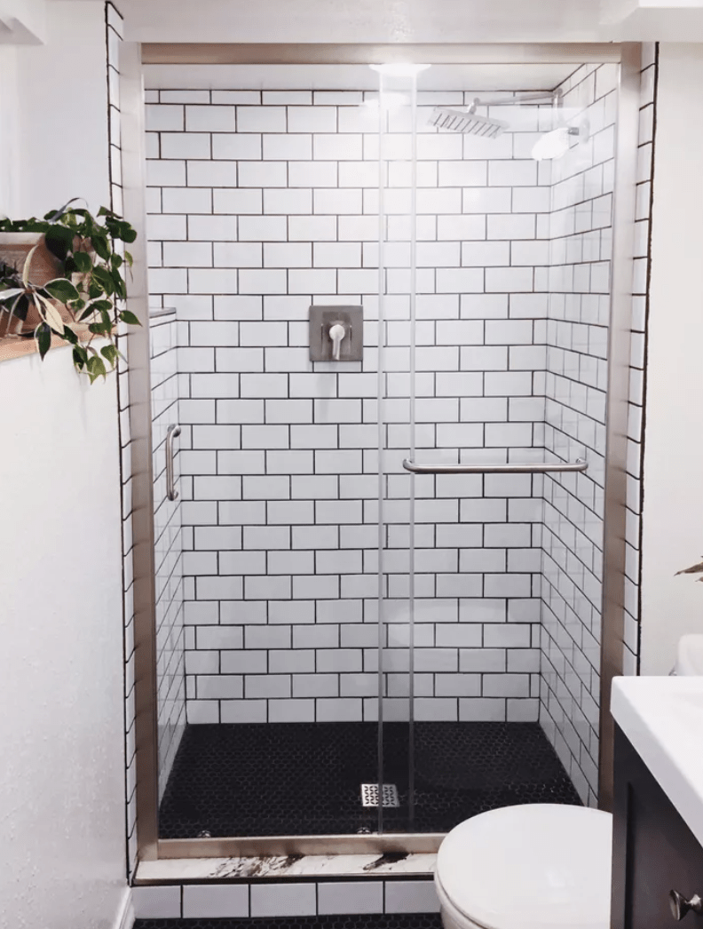 subway tile in basement bathroom walk in shower with glass door